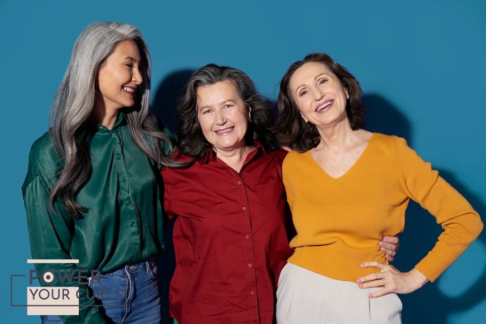 A group of older women looking healthy and smiling at the camera.